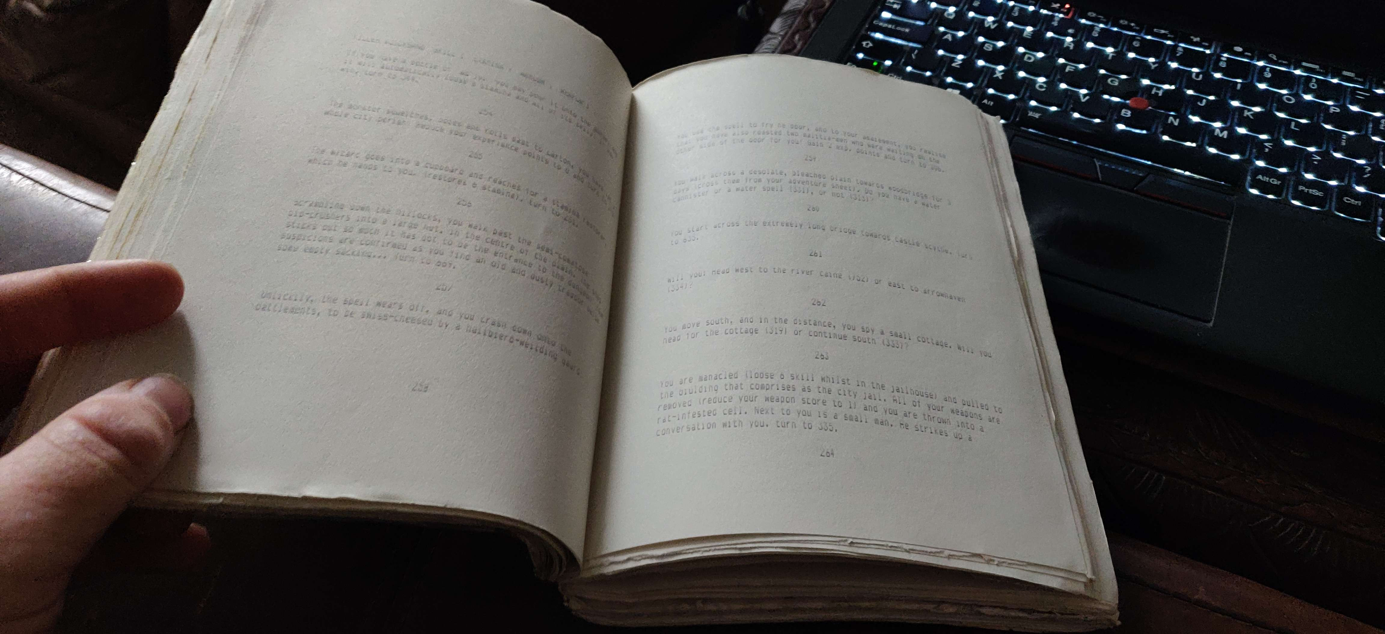 A5 dot-matrix print beside a backlit keyboard, text barely visible but preserved A5 dot-matrix print beside a backlit keyboard, text barely visible but preserved